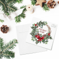 Kartka firmowa na Boże Narodzenie drukowana z motywem świątecznego wianka z dodatkiem liści i szyszek