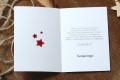 Piękne świąteczne życzenia, obok czerwone gwiazdki z efektem wyciętego papieru